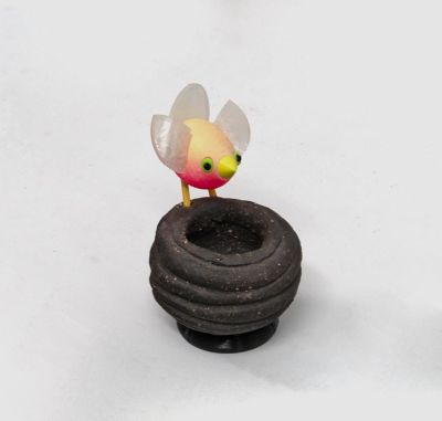 pink bird on black nest by Chris Barnes